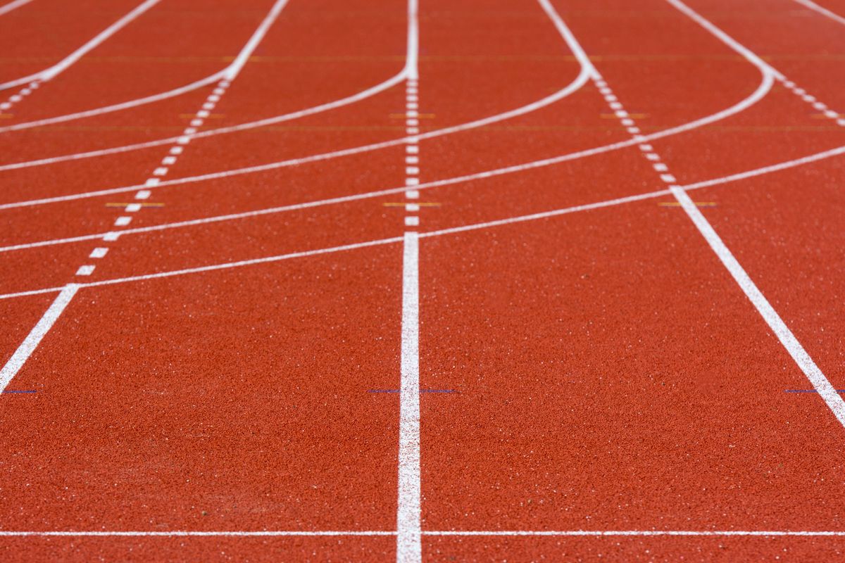 White lane markings curving across an empty running track